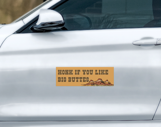 Weatherproof rectangular I Like Big Buttes car magnet by Ghost Poppy, featuring an illustration of desert rock formations and the text HONK IF YOU LIKE BIG BUTTES.