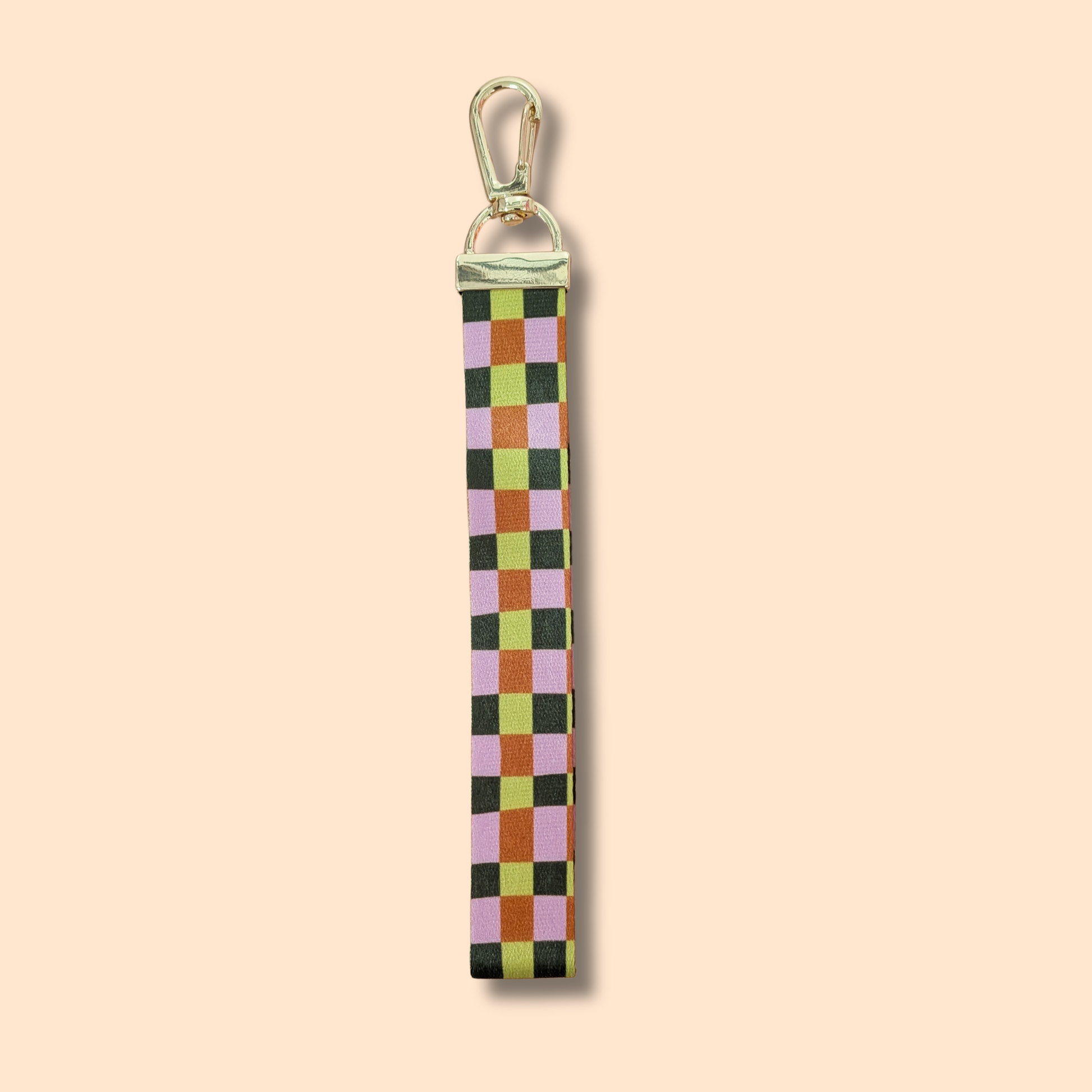 Elevate your fall style with the Ghost Poppy Fall Plaid Wristlet Lanyard Keychain—a chic wristlet featuring a gold clasp and a classic plaid pattern in green, pink, yellow, and brown on a light beige background. This stylish accessory is perfect for autumn!.