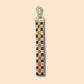 Elevate your fall style with the Ghost Poppy Fall Plaid Wristlet Lanyard Keychain—a chic wristlet featuring a gold clasp and a classic plaid pattern in green, pink, yellow, and brown on a light beige background. This stylish accessory is perfect for autumn!.