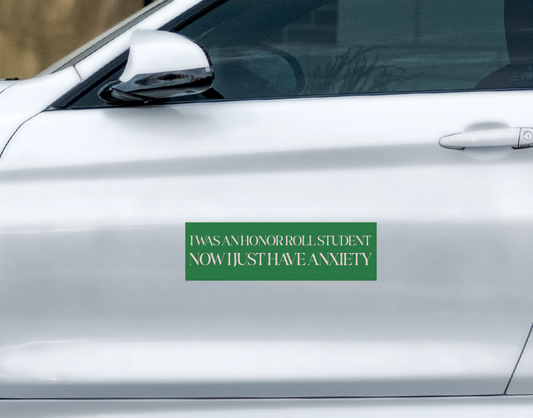 A rectangular, weatherproof green Ghost Poppy I Was A Honor Roll Student Car Magnet that reads I WAS AN HONOR ROLL STUDENT NOW I JUST HAVE ANXIETY in white capital letters.