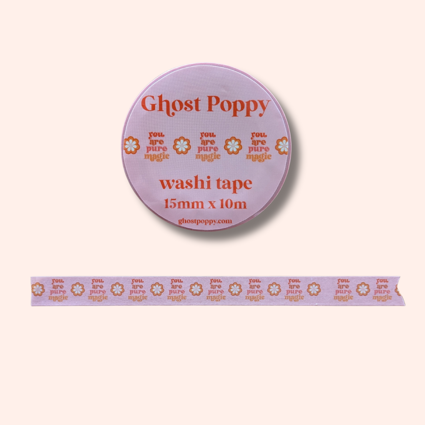 The Pure Magic Washi Tape by Ghost Poppy is a roll of pink rice paper tape, adorned with orange flowers and the uplifting phrase “you are pure magic” repeated along its length—an enchanting choice for journaling enthusiasts, shown here unrolled to display its charming design.