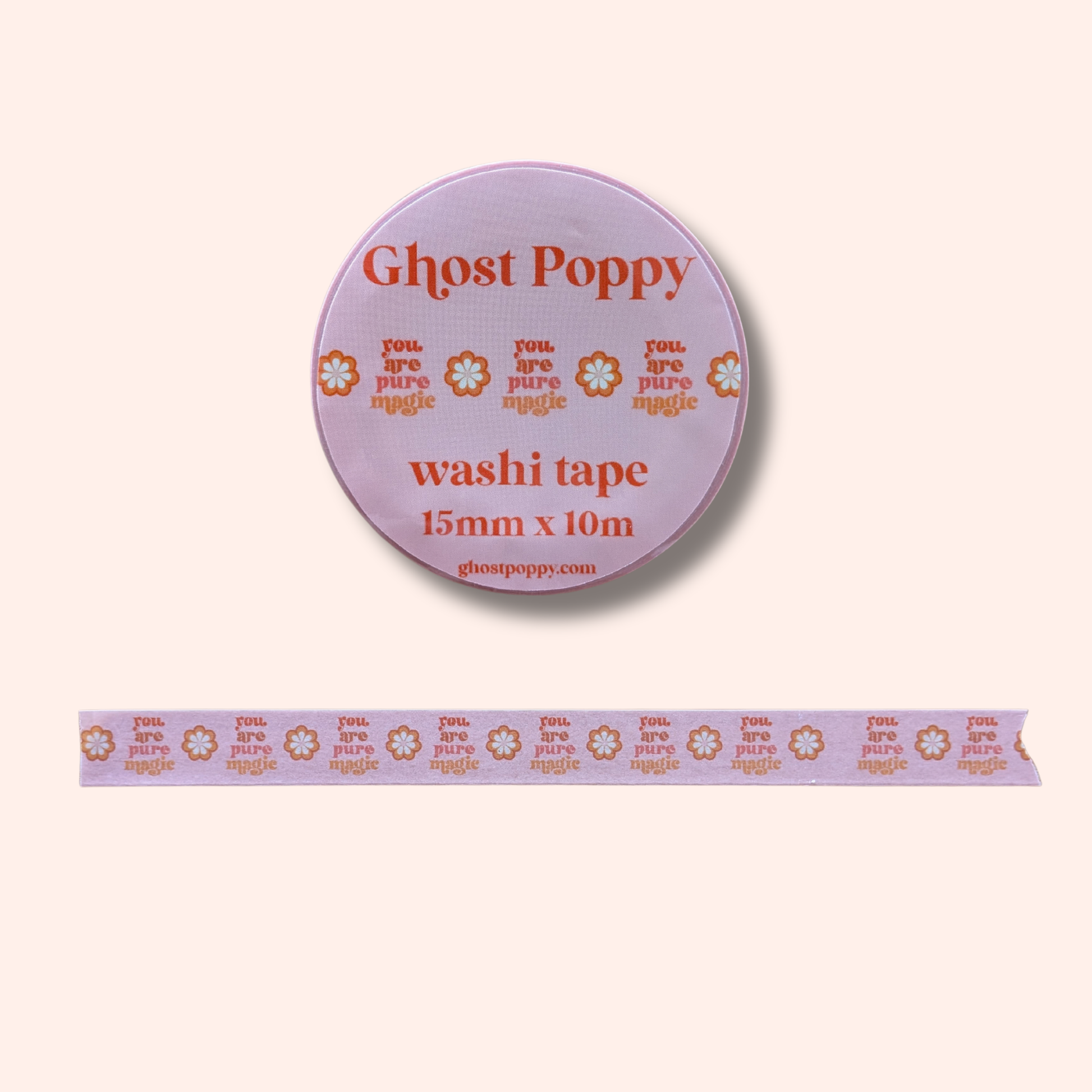 The Pure Magic Washi Tape by Ghost Poppy is a roll of pink rice paper tape, adorned with orange flowers and the uplifting phrase “you are pure magic” repeated along its length—an enchanting choice for journaling enthusiasts, shown here unrolled to display its charming design.